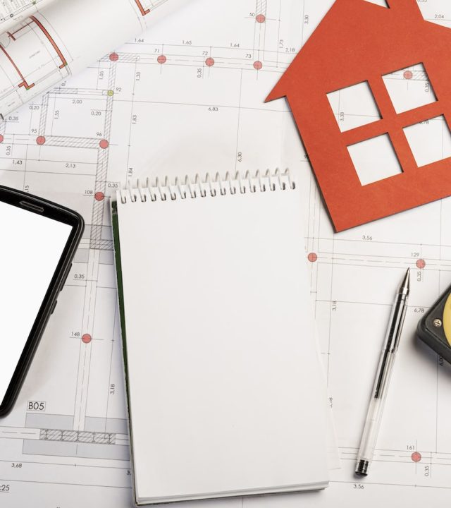 flat-lay-stationery-material-on-blueprint-min