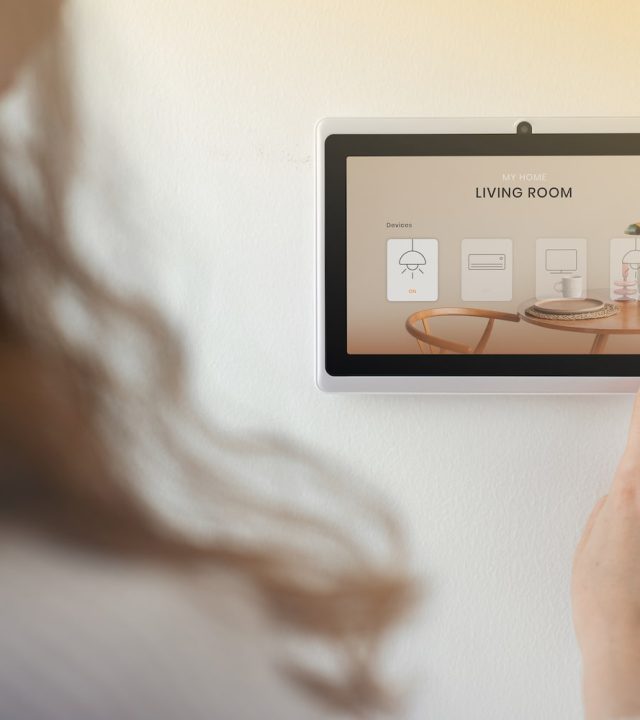 smart-home-innovation-technology-with-woman-using-control-panel-min